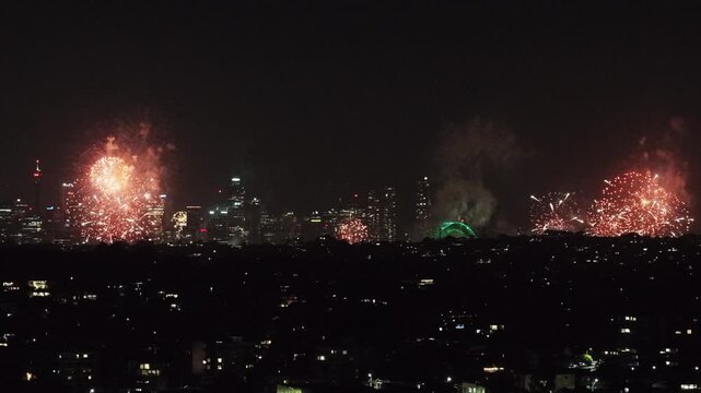 Midnight Sydney city New Year celebration fireworks displays over Harbour from Manly.