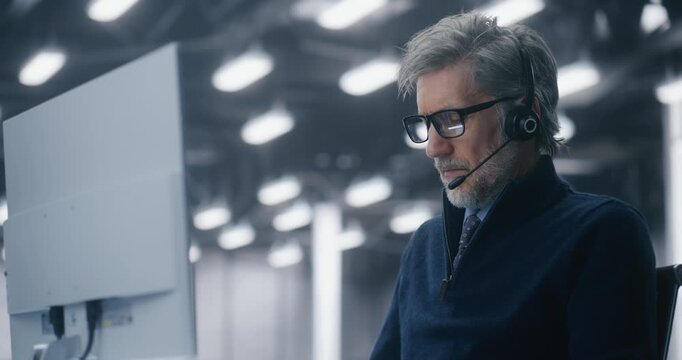 Close Up of Male IT Consultant Participating in Video Call Using Headset and Microphone in Modern High Tech Facility. Concept of Remote Teamwork, Consultation, and Data Infrastructure Planning. - Powered by Adobe