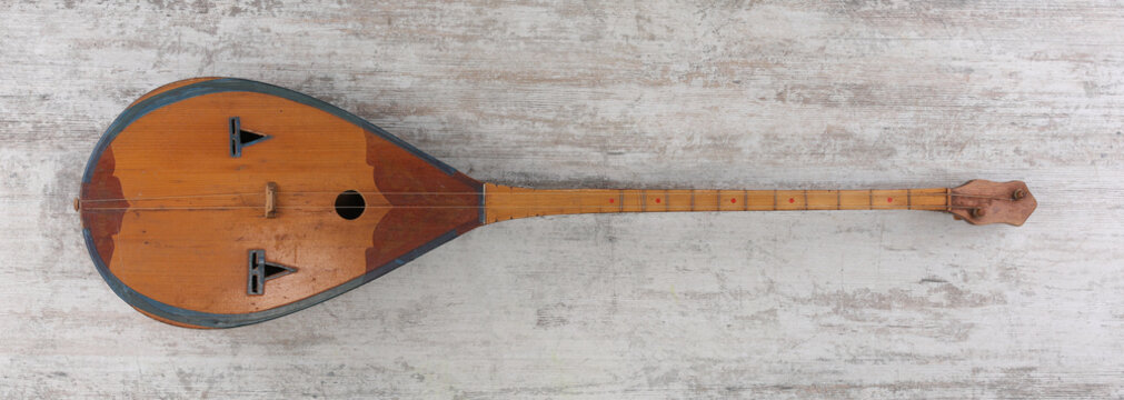 Kazakh string musical dombra on a wooden background