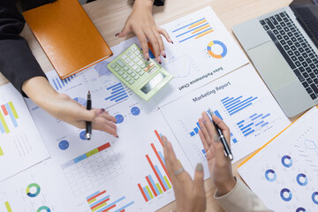 Hands of businesswoman with calculator and analyzing financial chart on paperwork on tablet in...