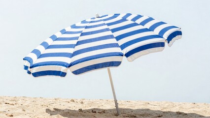 Blue and white striped beach umbrella on sandy shore