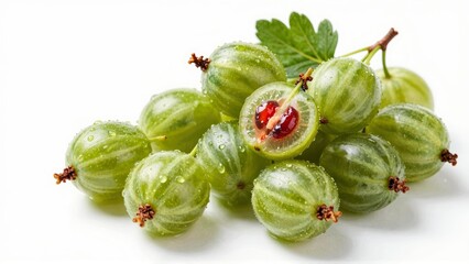 Fresh green gooseberries with water droplets and cut open fruit
