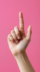 Hand pointing up pink background.