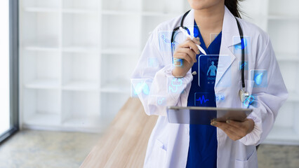 Female doctor holding a stethoscope, Healthcare And Medicine concept. Doctor using digital tablet with modern virtual screen interface.