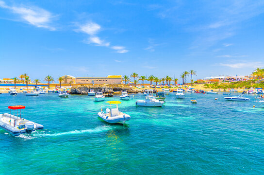 Yachts and motor boats anchored in lagoon water of Mediterranean Sea Alicante bay near coast Tabarca Island Nueva Tabarca Isla Plana in sunny summer day, Alicante province, Valencian Community, Spain