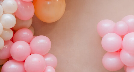 Pastel balloon frame with pink, peach and white balloons on soft beige background. Minimal festive border with copy space for birthday, baby shower, wedding or celebration design.