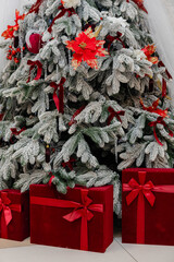 Decorated Christmas tree with red ornaments and gift boxes underneath. Festive winter holiday scene with frosted branches, perfect for Christmas, New Year, holiday greeting or seasonal design.
