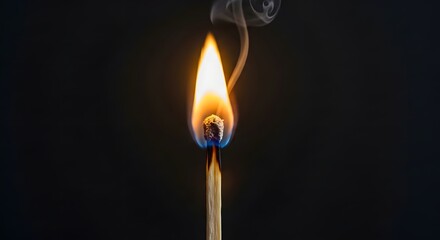Striking close up of a single wooden match burning brightly with wisps of white smoke curling against a deep black background