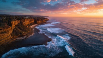 Fototapeta premium Stunning coastal sunset over rocky cliffs and ocean waves.