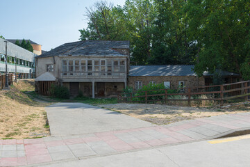 Traditional rural stone house with wooden gallery and slate roof