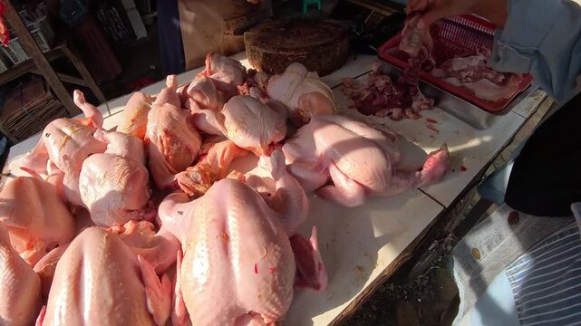 Clip of freshly cut chicken meat at chicken meat broilers in a traditional Indonesian market. Videography of buying chicken meat in a traditional market in 4K HD resolution.
