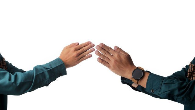 Two Asian men in traditional Muslim outfits performing an Eid greeting gesture. Hands meet respectfully, symbolizing forgiveness and celebration. Isolated on white background.