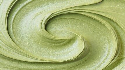 Delicate matcha powder, featuring subtle green ripple patterns and smooth swirls, highlighting the natural vibrant color of the green tea powder and its fine, powdery texture.
