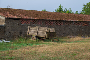 Traditional rural stone house with wooden gallery and slate roof