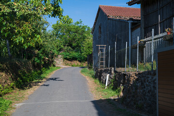 Traditional rural stone house with wooden gallery and slate roof