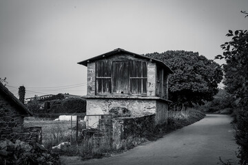 Traditional rural stone house with wooden gallery and slate roof