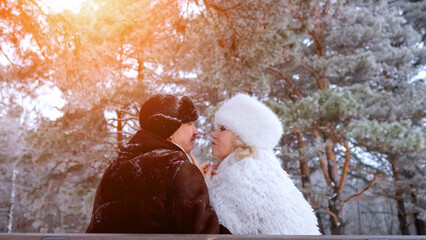 Lovers Embrace Outdoors, Couple Beneath Trees Playfully Flirt, Retired Dancers Share Tender Glance On Park Pathway, Sunlit Winter Scene With Joyful Couple Exchanging Teasing Glances