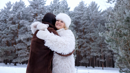 Couple Shares Joy, Lovers Embrace In Winter Landscape, Pair Enjoys Festive Season In Snowy Setting, Cheerful Duo Celebrates Special Occasion Surrounded By Icy Pine Trees And Cozy Attire