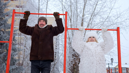 Elderly Couple Exercises With Determination, Older Adults Train In Winter Outdoors With Joyful Effort, Senior Citizens Engage In Outdoor Physical Activity Amid Snowy Scenery And Cold Weather