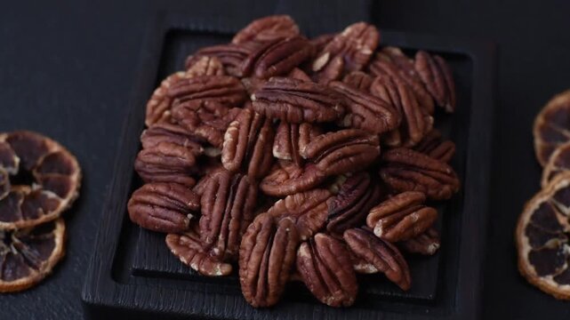 Peeled and roasted pecan nut as an ingredient for healthy foods and snacks. Pecan nut as a food background for your design.