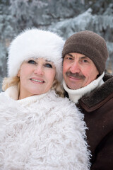 Elderly Couple Enjoying Snowy Walk, Loving Seniors Immersed In Snowy Forest During Holiday Season, Happy Elderly Couple Embracing In Snowy Woods With Festive Atmosphere And Heartfelt Laughter