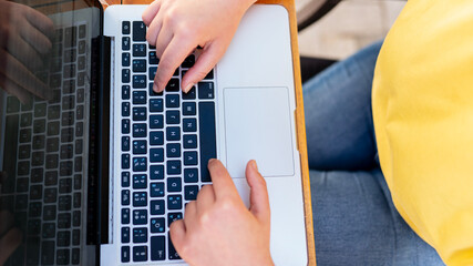 young woman working outdoors with a laptop