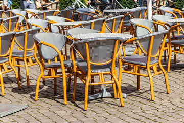 Chairs and tables in cozy outdoor cafe