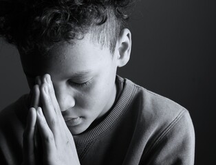 little boy praying to God with hands together with people stock image stock photo 