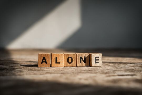 alone letter on wooden cubes, concept of depressions and loneliness, sadness and frustration - Powered by Adobe
