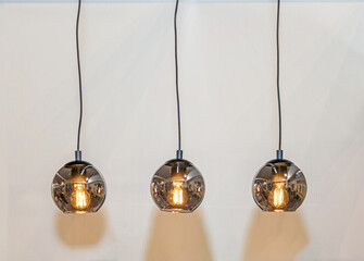 Electric lamps hanging from a ceiling in modern interior