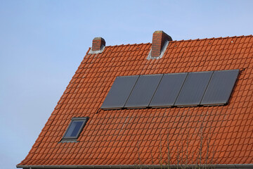 Row of rooftop solar panels mounted on private home