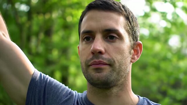 Man practicing tai chi in green forest for peaceful mind and body wellness