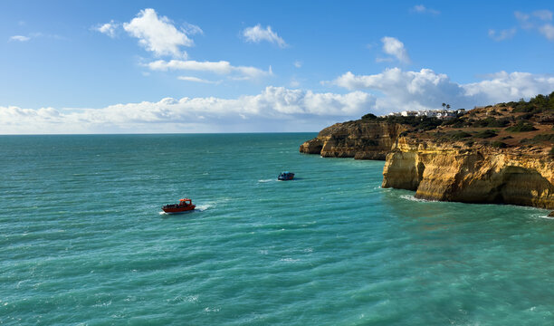 Golden rock cliffs at the coastline of the Atlantic Ocean with beach Praia da Corredoura near the Cave of Benagil, Algarve, Portugal
