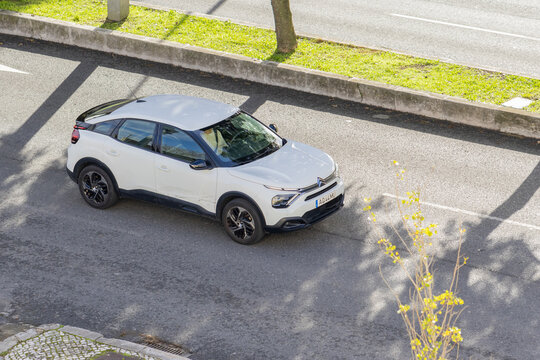White citroen c4 crossover car driving on urban street