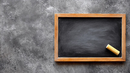 Blackboard with chalk on a gray surface near learning tools
