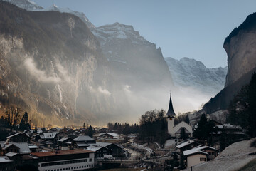 panorama of the mountains, Dramatic morning light over Lauterbrunnen village and church, Swiss Alps.