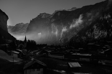 Dramatic morning light over Lauterbrunnen village and church, Swiss Alps.