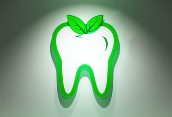 Green leaf tooth logo with stars on dental office wall