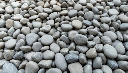 A close-up view of numerous smooth, rounded grey pebbles scattered naturally, creating a beautiful organic texture and background,  collection,  aggregate