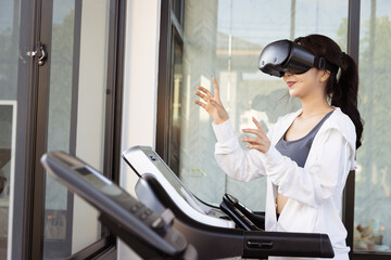 Asian beautiful woman with virtual reality glasses touches invisible screen in air before running...