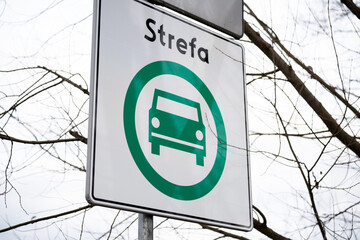 D-54 road sign for the Clean Transport Zone (SCT, Strefa Czystego Transportu) in Krakow, Poland. Ban on older cars from city streets to reduce pollution, effective January 1, 2026. Strefa means Zone. © Longfin Media