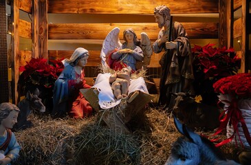 The Nativity Scene surrounded by holly and poinsettia leaves, Baby Jesus, Christmas