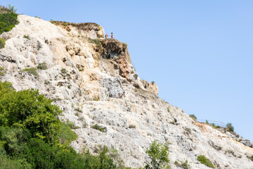 Water mills park (Parco dei Mulini) - people on the hot springs at Bagno Vignoni, municipality of San Quirico d'Orcia, Province of Siena, Tuscany, Italy