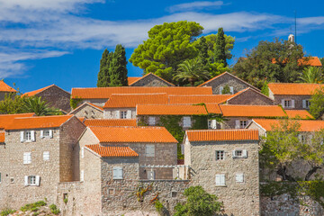 Sveti Stefan stone walls and red tile roofs. Montenegro