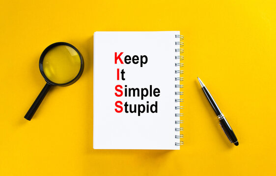 Keep it simple stupid principle on notebook with stationery