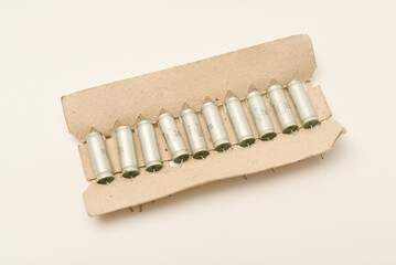 Old capacitors in paper packaging. Aluminum capacitors for electronic devices.