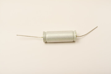 Old capacitors in paper packaging. Aluminum capacitors on a white background. Electronic components.