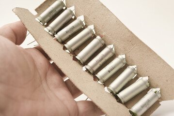 Old capacitors in paper packaging. Aluminum capacitors for electronic devices.