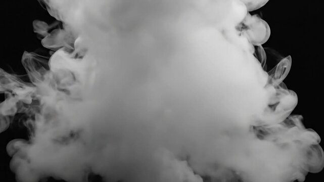 Abstract slow motion white smoke cloud explosion against black background, studio shot with dynamic shapes