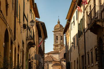 street at dusk with a view to the church in San Quirico d'Orcia, Province of Siena, Tuscany, Italy